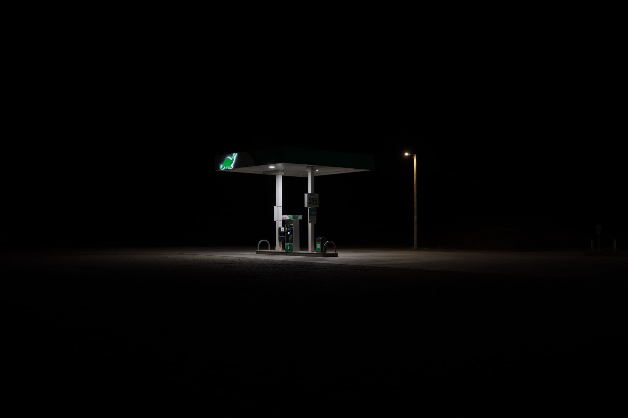 Gas station surrounded by pitch black night