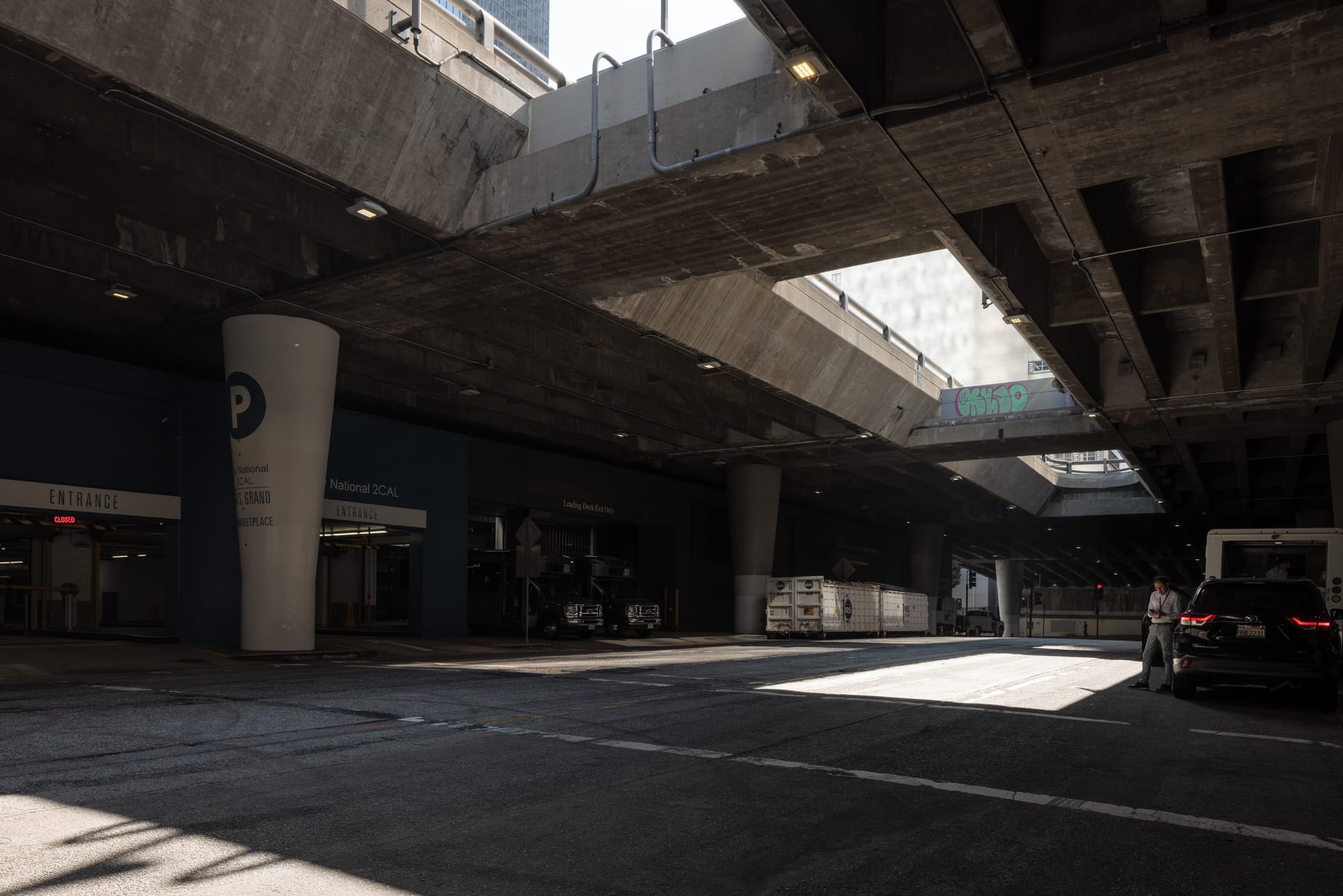 An architectural photo of Broad street in Los Angeles, with light coming in from the openings to the street above.